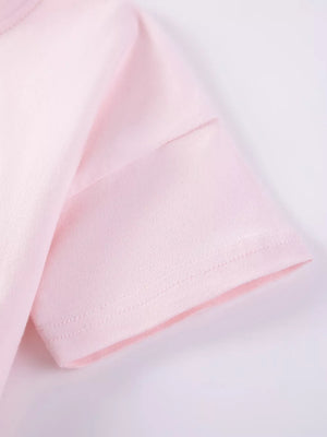 Toddler blush pink t-shirt with short sleeves and a clean hem.