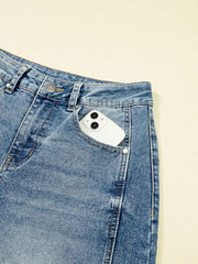 Vintage-inspired high-waisted seam jeans in light wash denim with a phone in the pocket.