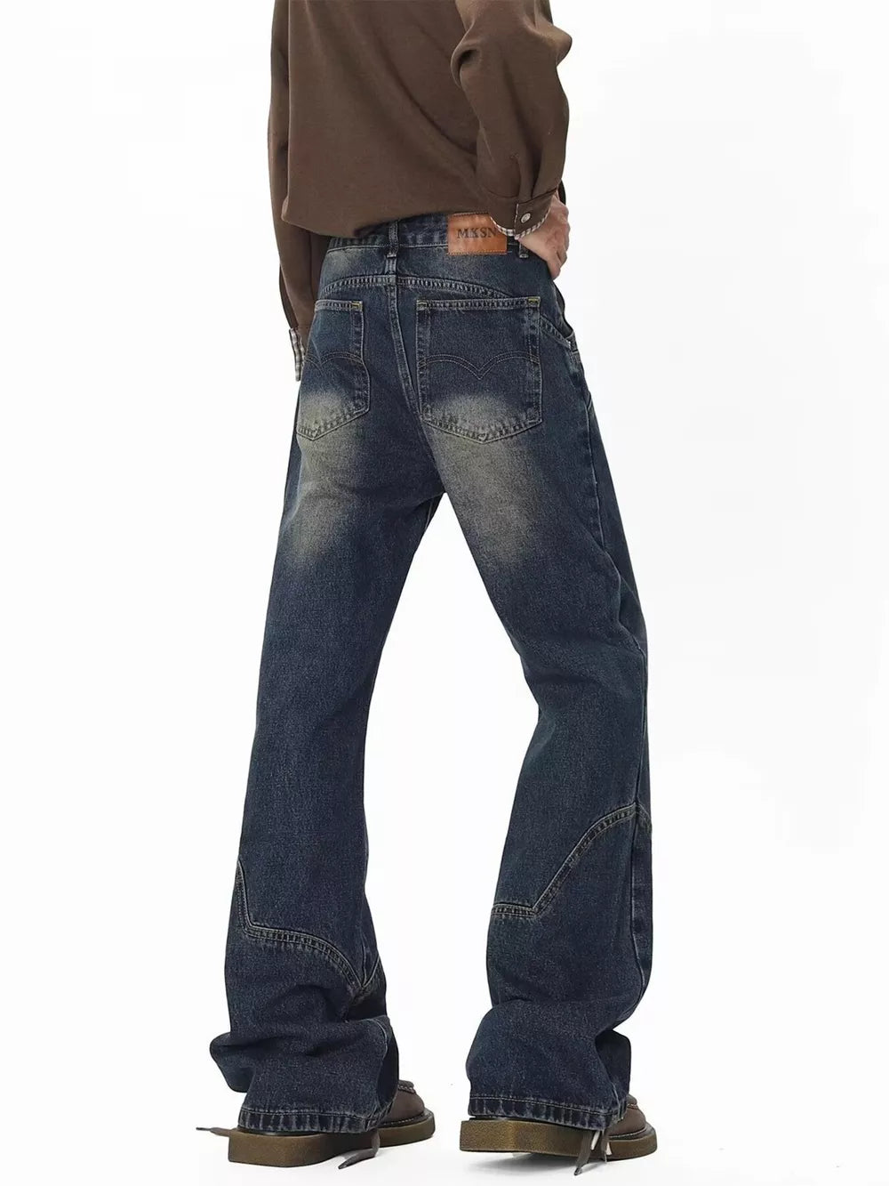 Men's vintage wash wide leg jeans with distressed details and a relaxed fit.
