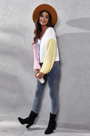 Colorblock knit cardigan with balloon sleeves in white, pink, and yellow acrylic.
