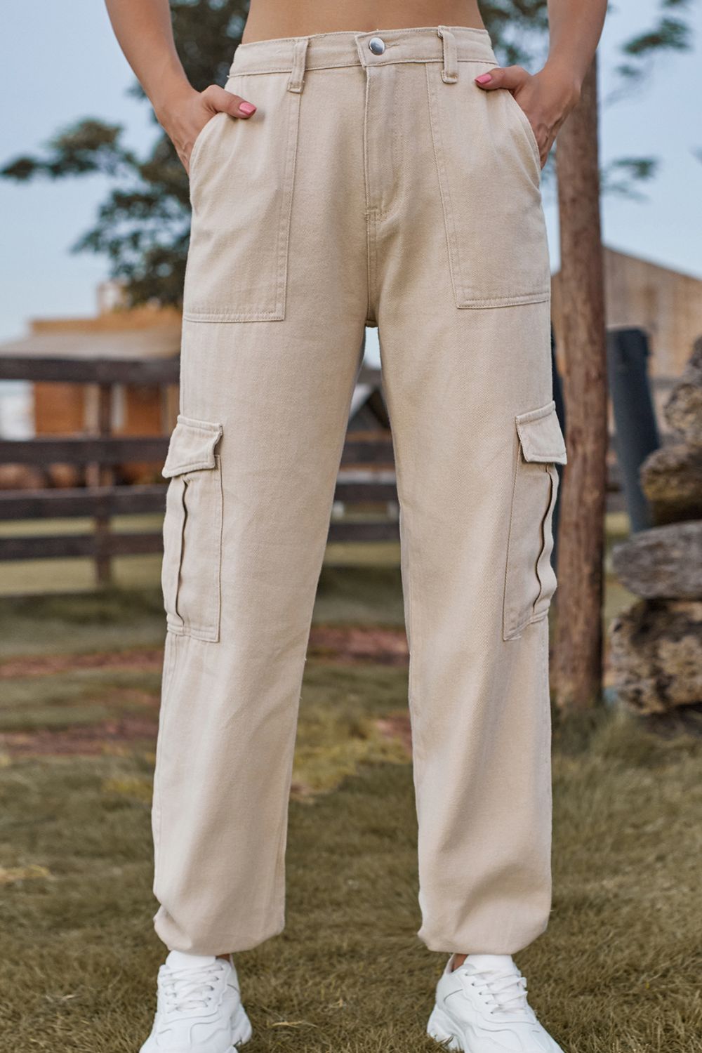 Tan utility cargo pants with multiple pockets and a relaxed fit.