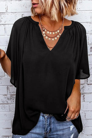 Black relaxed V-neck blouse with cap sleeves and gathered neckline detail.
