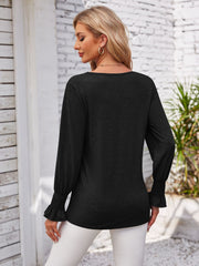 Black blouse with blouson sleeves and ruffled cuffs