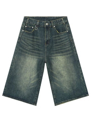 Wide-leg distressed denim culottes in a vintage blue wash with a buttoned fly and metal D-ring detail.