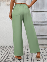 Green drawstring wide-leg pants with back pockets and elastic waistband.