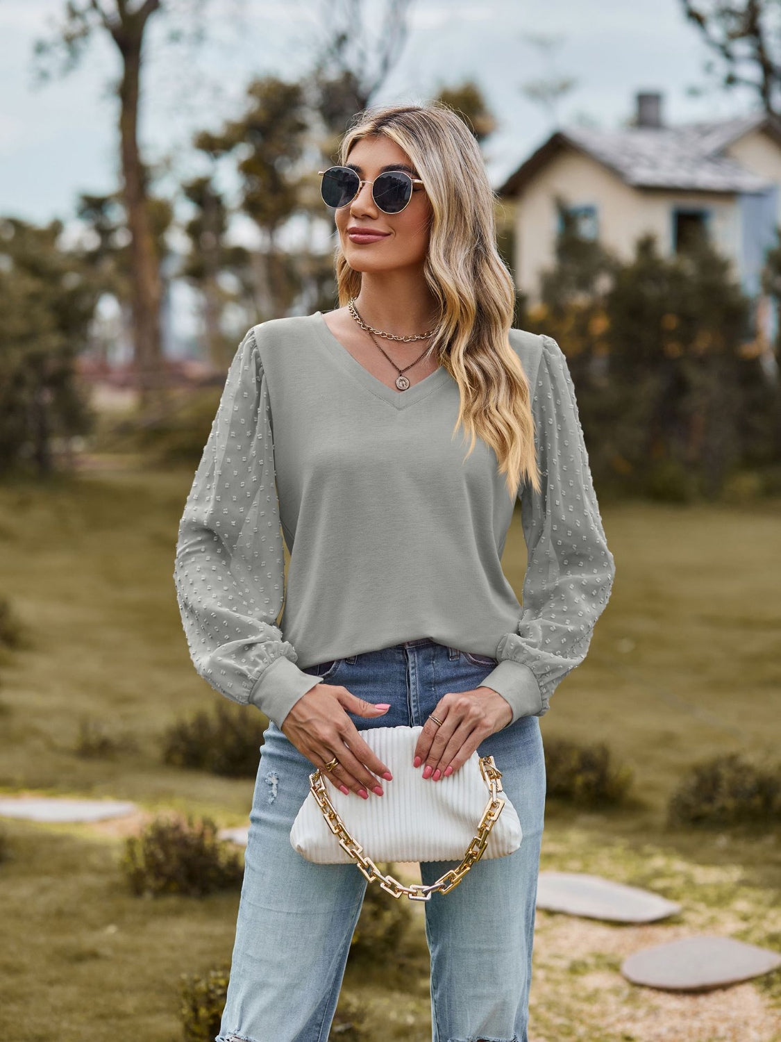 Gray V-neck blouse with Swiss dot sheer puff sleeves and a relaxed fit.
