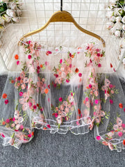 White off-shoulder t-shirt with allover floral embroidery and sheer sleeves.