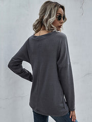 Dark gray waffle knit crossover blouse with long sleeves and a relaxed fit.