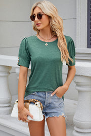 Green tee with gathered sleeves and gold buttons, crew neck, short sleeves.