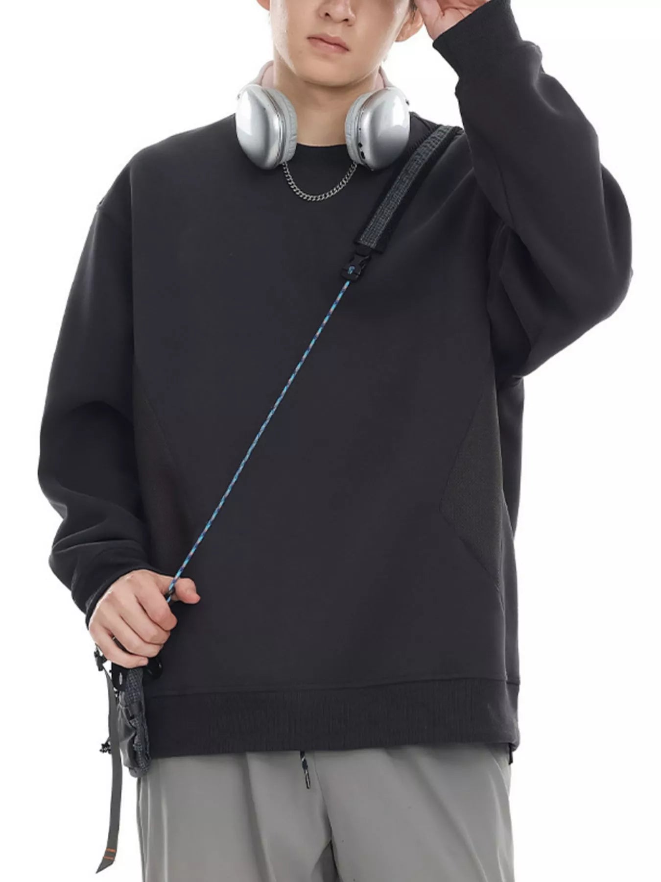 Oversized black cotton crew-neck sweatshirt with textured panel detail.