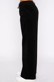 Black velvet lounge pants with drawstring waist and wide legs.