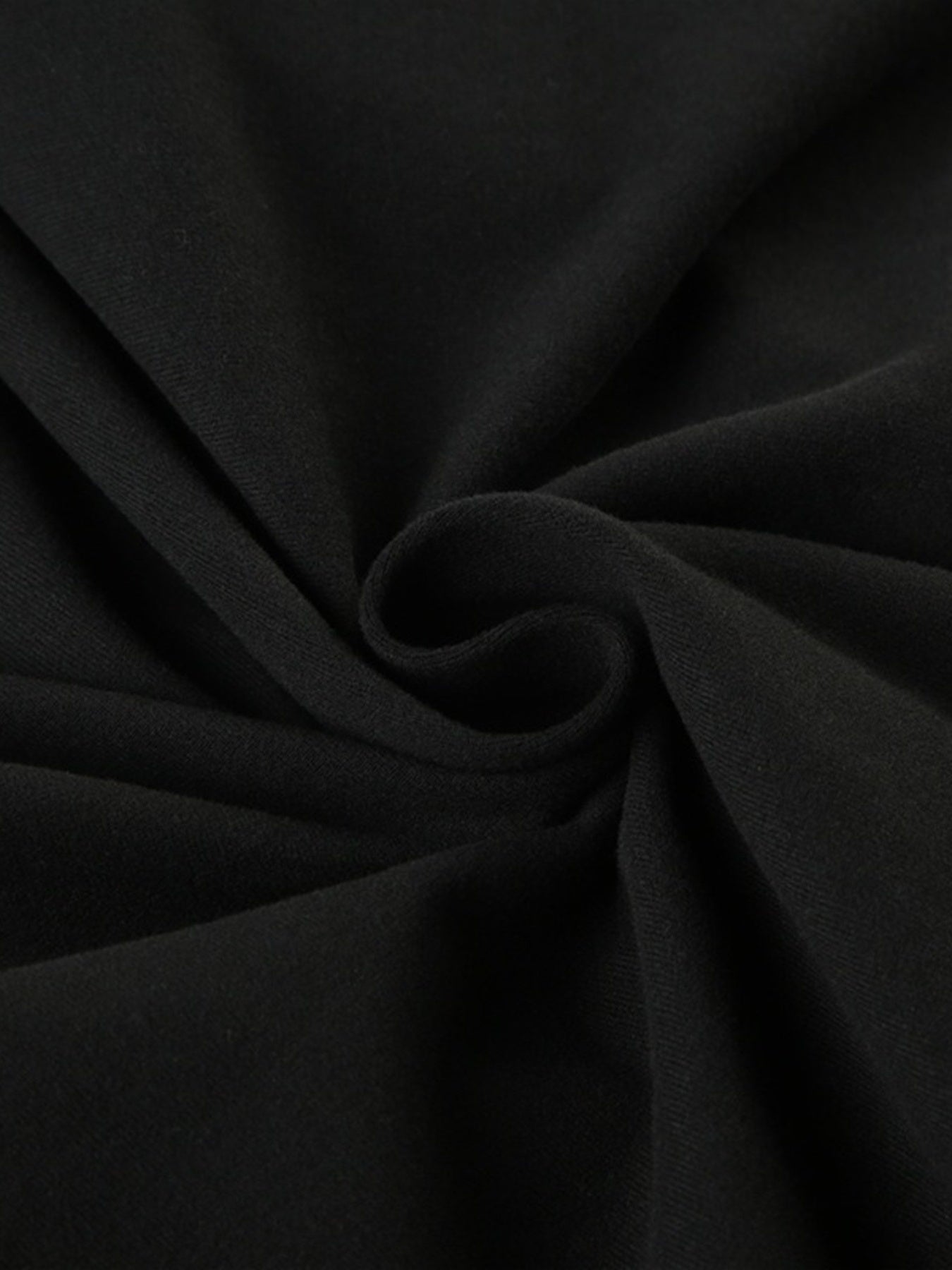 Black long-sleeve active romper with boat neck, showing fabric texture.