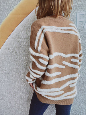Tan knit crewneck sweater with textured white stripe pattern