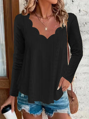 Black scalloped eyelet yoke blouse with long sleeves and a v-neckline.