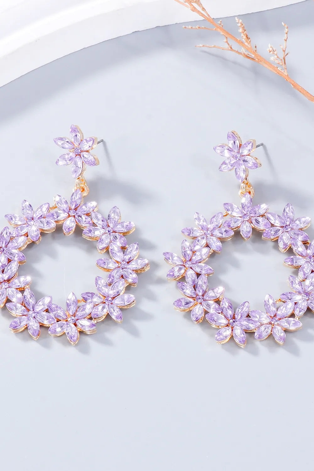 Floral halo drop earrings in pink purple with crystal flowers and gold alloy details.
