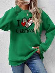 Green crewneck sweatshirt with festive heart graphic and Santa Claus detail.