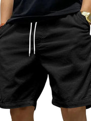 Black corduroy drawstring shorts with relaxed fit and white drawstrings.