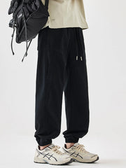 Black relaxed fit joggers with drawstring waist and elastic cuffs.