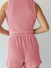 Chic sleeveless coord set in blush pink ribbed knit, featuring a tank top and shorts with elastic waist.