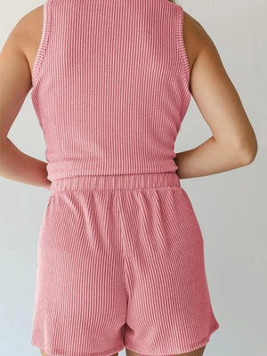 Chic sleeveless coord set in blush pink ribbed knit, featuring a tank top and shorts with elastic waist.
