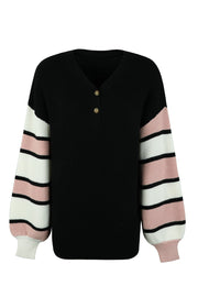 Black waffle knit henley sweater with striped sleeves in pink, white, and black.