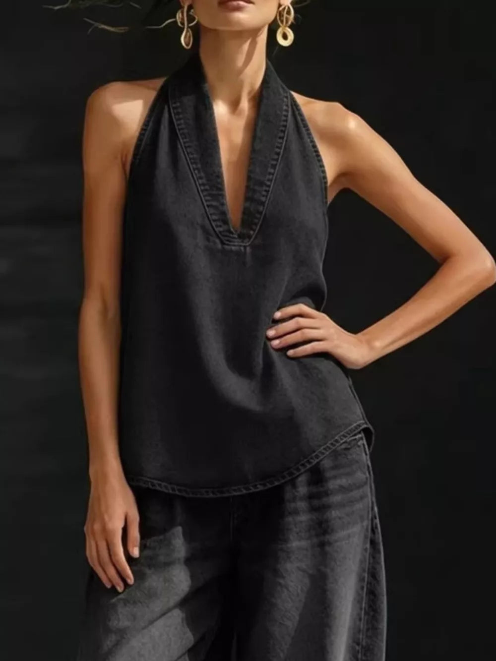Black denim halter top with deep V-neck and wide-leg pants ensemble.