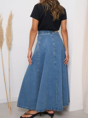 High-waisted A-line denim maxi skirt in light blue, with a full, flowing silhouette.