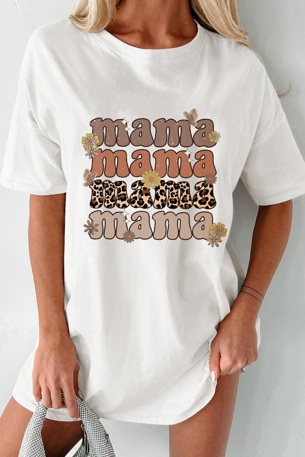 White cotton oversized tee dress with stacked "mama" graphic and floral accents.