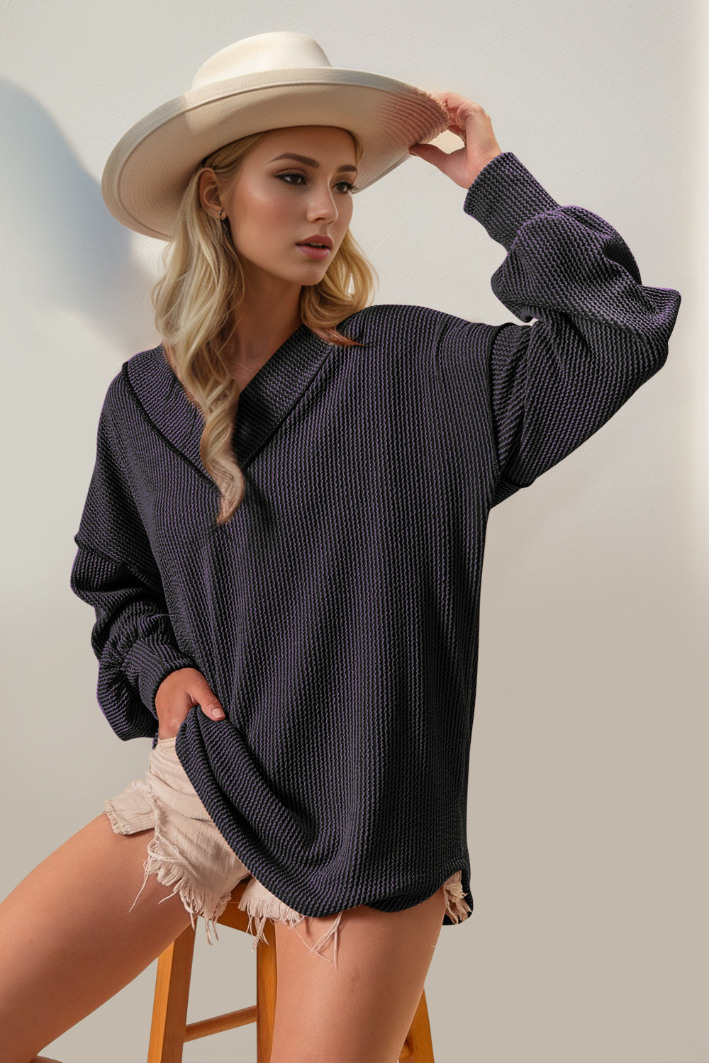 Relaxed purple waffle knit collar top with balloon sleeves and a V-neck.