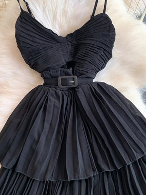 Black pleated midi dress with spaghetti straps and a belted waist.