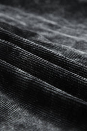Textured corduroy overshirt in faded black with visible ridges and soft nap.