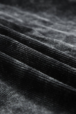 Textured corduroy overshirt in faded black with visible ridges and soft nap.