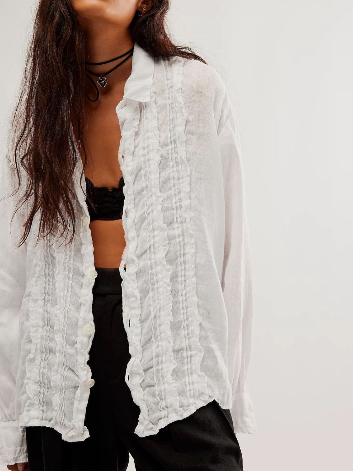 White linen button-down blouse with ruffled front detail