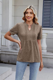 Khaki pleated yoke keyhole tee with short sleeves and a relaxed fit.