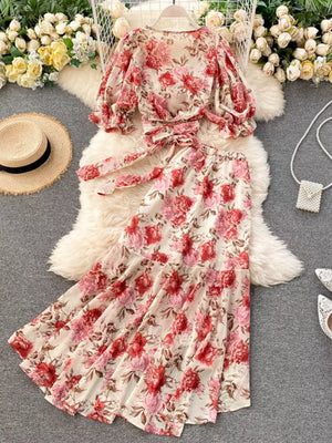 Chic floral two-piece crop set with puff sleeves and a tie waist, featuring a pink and red floral print on a cream