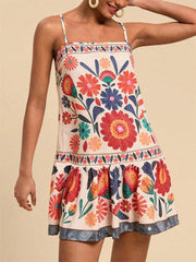 Playful printed mini dress with spaghetti straps, square neckline, and ruffled hem in multicolor.