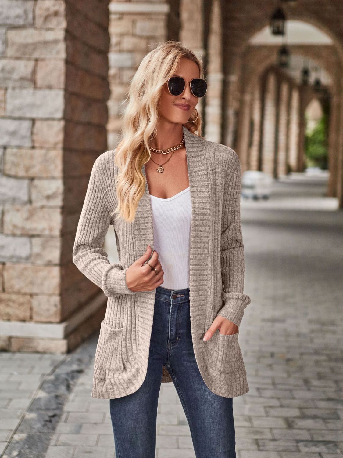 Tan textured ribbed open-front cardigan with pockets and a relaxed fit.