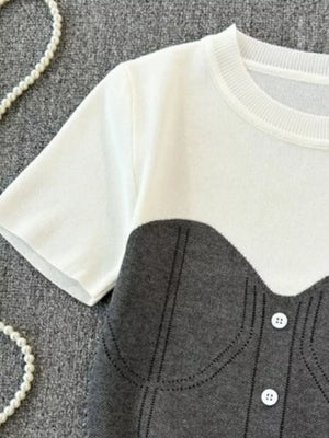 Color block knit t-shirt in white and gray with ribbed detail and button accents.