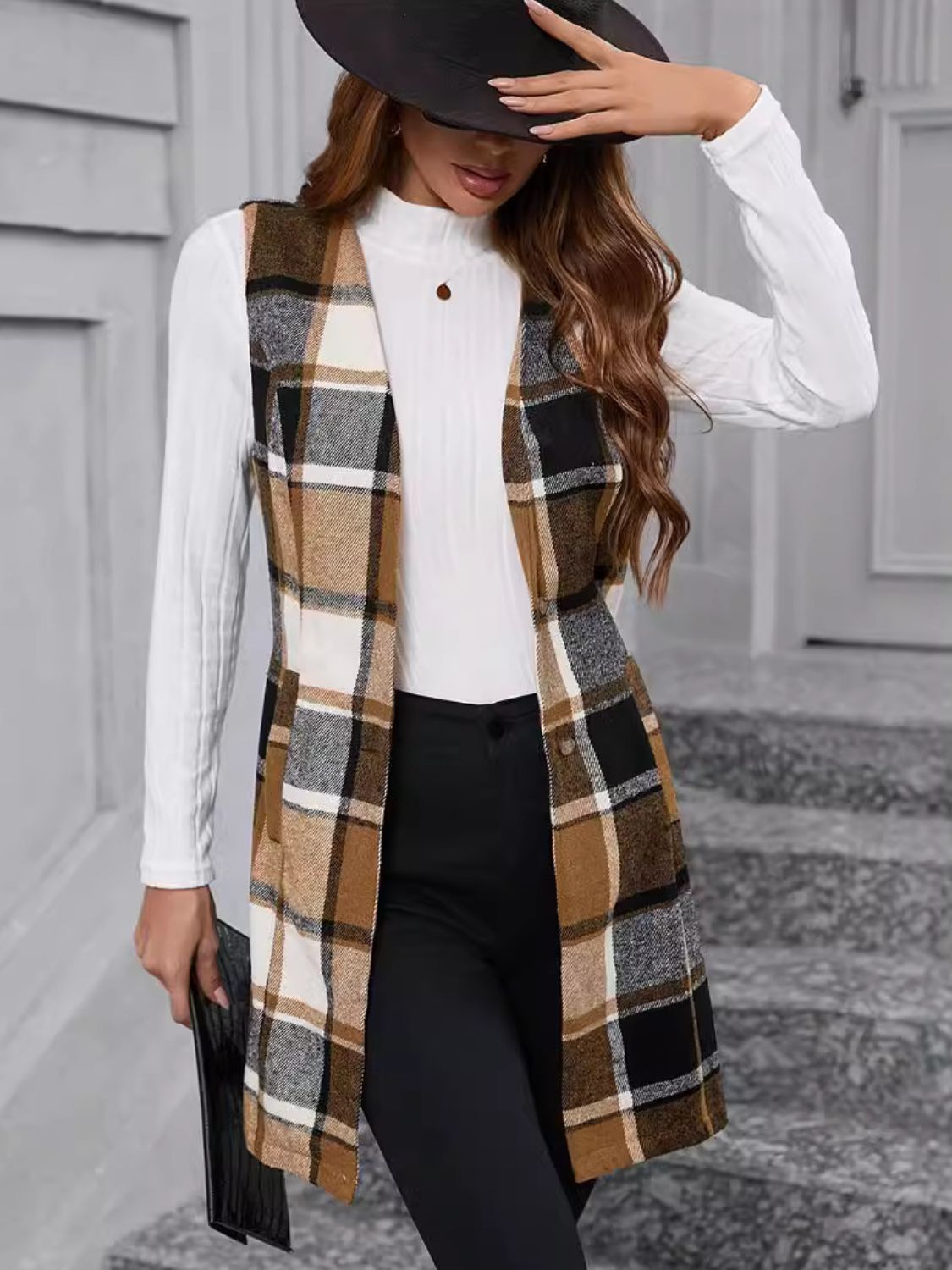 Tartan longline vest in camel, black, and white plaid with a buttoned front.