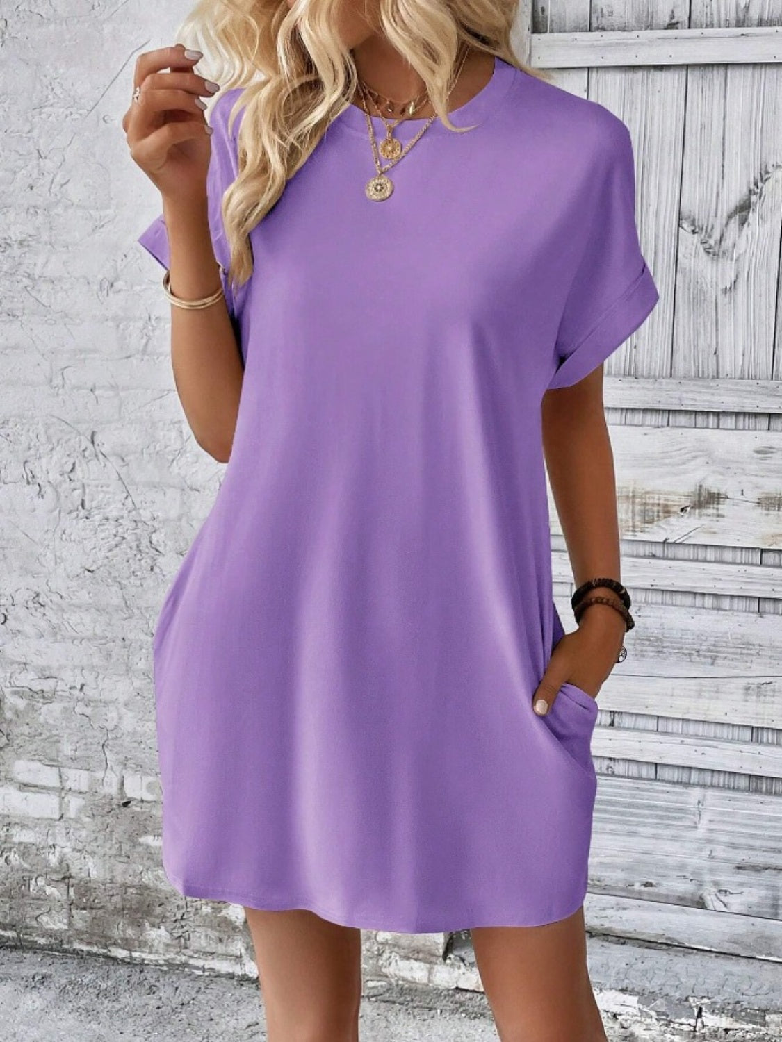 Relaxed tee dress in lavender with cuffed sleeves and pockets.