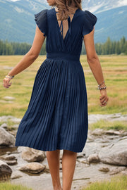 Dark Blue pleated dress with flutter sleeves, smocked waist, and tie back detail.