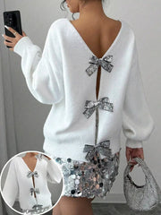 White knit cardigan with sequin bow details on the back and front closure.