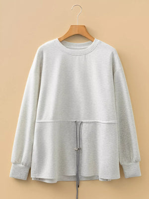 Light gray tunic sweatshirt with drawstring waist detail and crew neck.