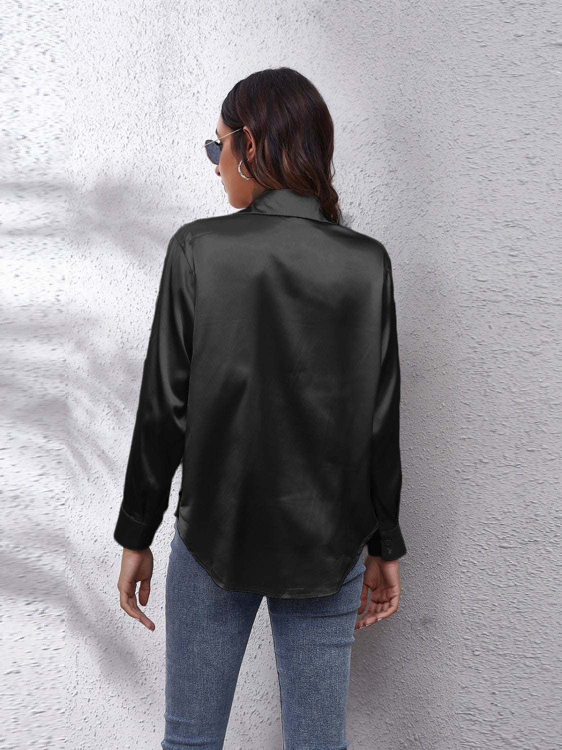 Black satin collared button-down shirt with long sleeves and a curved hem.