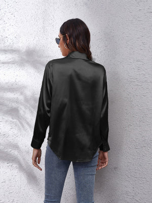 Black satin collared button-down shirt with long sleeves and a curved hem.