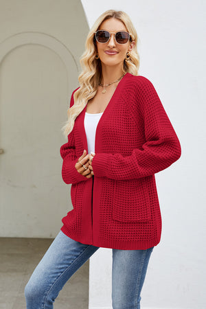 Red waffle knit raglan pocket cardigan with long sleeves and open front.