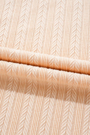 Textured ribbed sleeveless collar jumpsuit in eggshell with a chevron pattern.