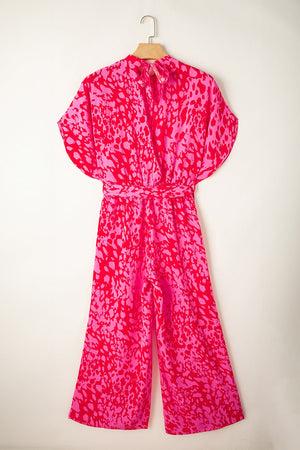 Crimson Splatter Tie-Waist Palazzo Jumpsuit in hot pink with a bold splatter print and wide legs.