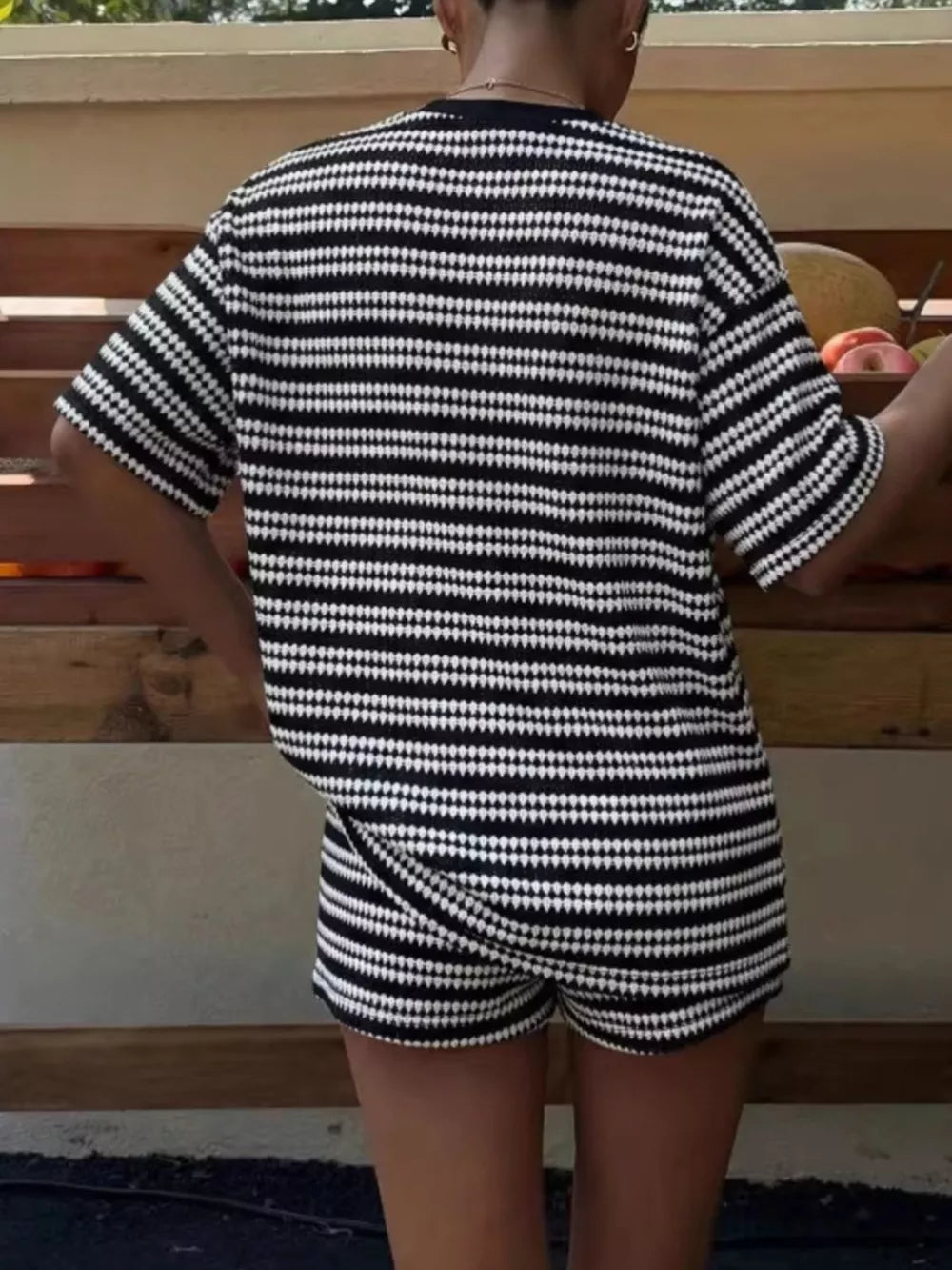 Black striped relaxed fit two-piece set with short sleeves and shorts.