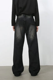 Faded wash wide leg denim jeans in dark with a relaxed fit and visible pocket details.